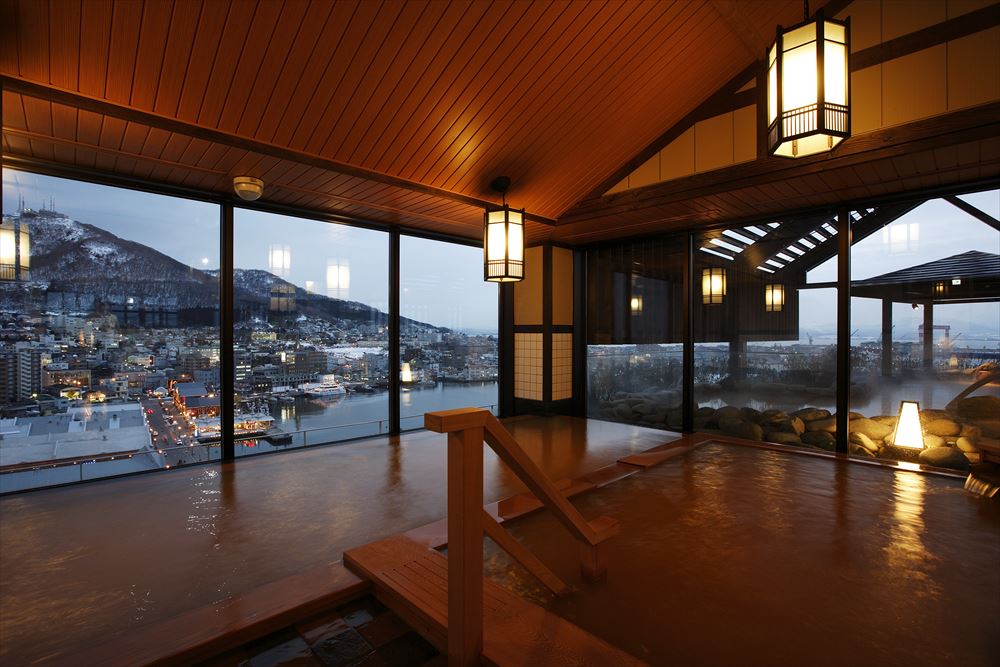 LA VISTA Hakodate Bay_Indoor bath of the large common bathing area. Matching the subdued lighting, these tea-colored waters beautify the skin.