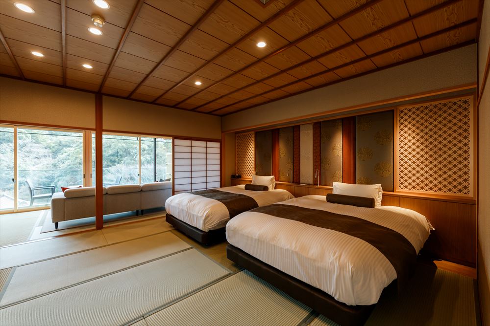 Tachibana Shikitei. Japanese Jr. suite including hinoki open-air bath with view: a 12.5-tatami twin bedroom, a 7.5-tatami lounge with sofa and an open-air bath made of hinoki (Japanese cypress).