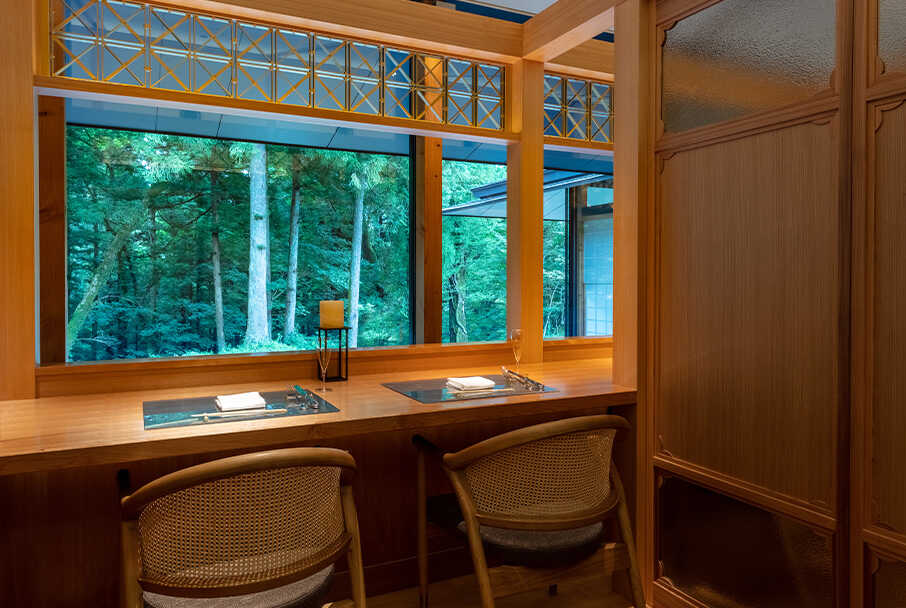 FUFU NIKKO JAPAN_Restaurant Setchu. Two-person seating overlooking the garden provides a serene space enveloped in the warm fragrance of wood.