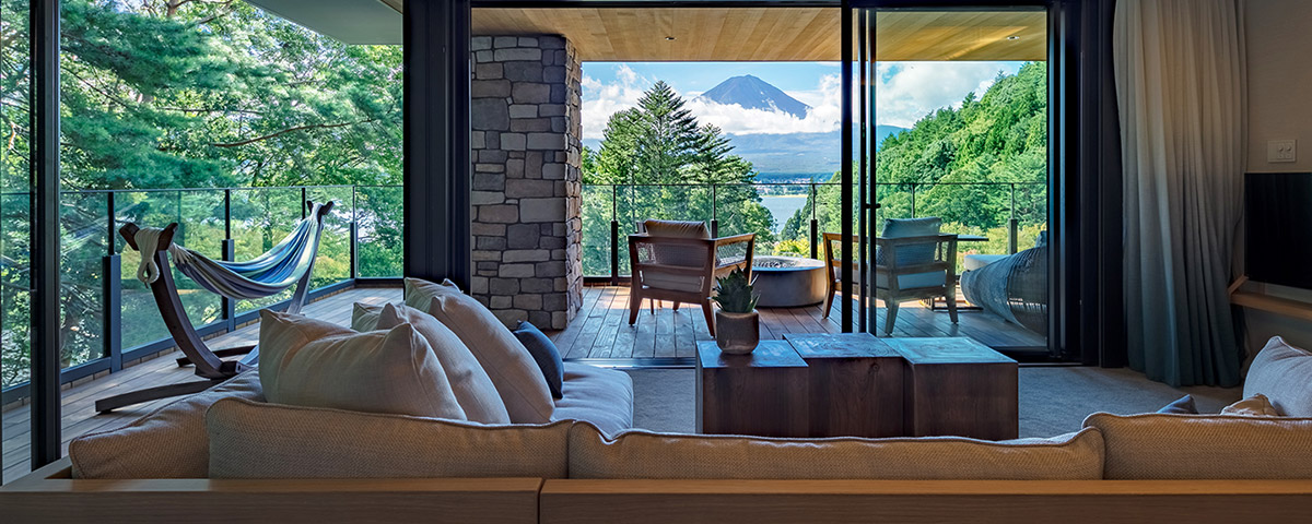 FUFU KAWAGUCHIKO JAPAN_FUFU Luxury Premium Suite. Open the sliding glass doors to join the living room with the spacious balcony and the spectacular view of Lake Kawaguchiko beyond. Sway in the hammock, warmed by the bioethanol fireplace, for a moment you’ll wish to never end.