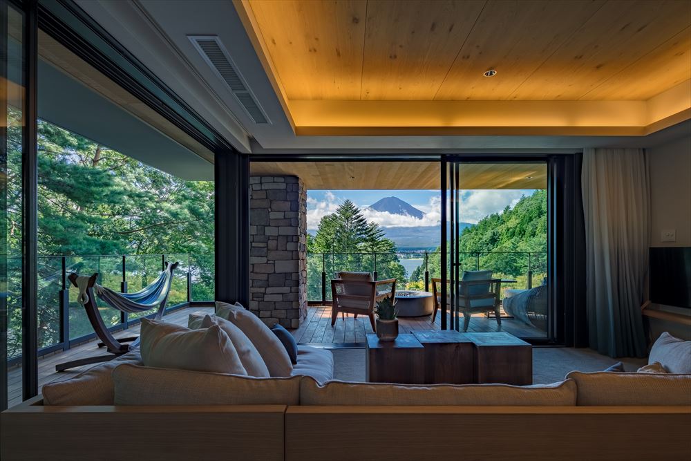 FUFU KAWAGUCHIKO JAPAN_FUFU Luxury Premium Suite. Open the sliding glass doors to join the living room with the spacious balcony and the spectacular view of Lake Kawaguchiko beyond. Sway in the hammock, warmed by the bioethanol fireplace, for a moment you’ll wish to never end.