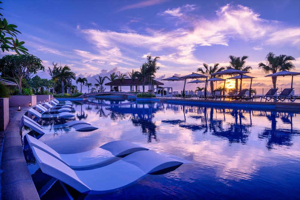 「オリエンタルホテル 沖縄リゾート＆スパ」のガーデンプールの夕景。